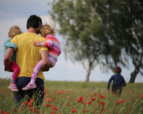 Man in Field with Family